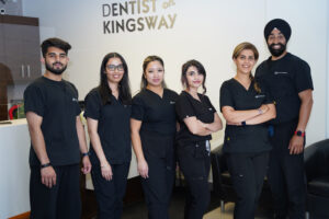 The Dentist on Kingsway dental team in scrubs at the clinic reception in Vancouver, BC