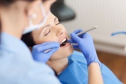 Dental hygienist carrying out a comprehensive exam and cleaning